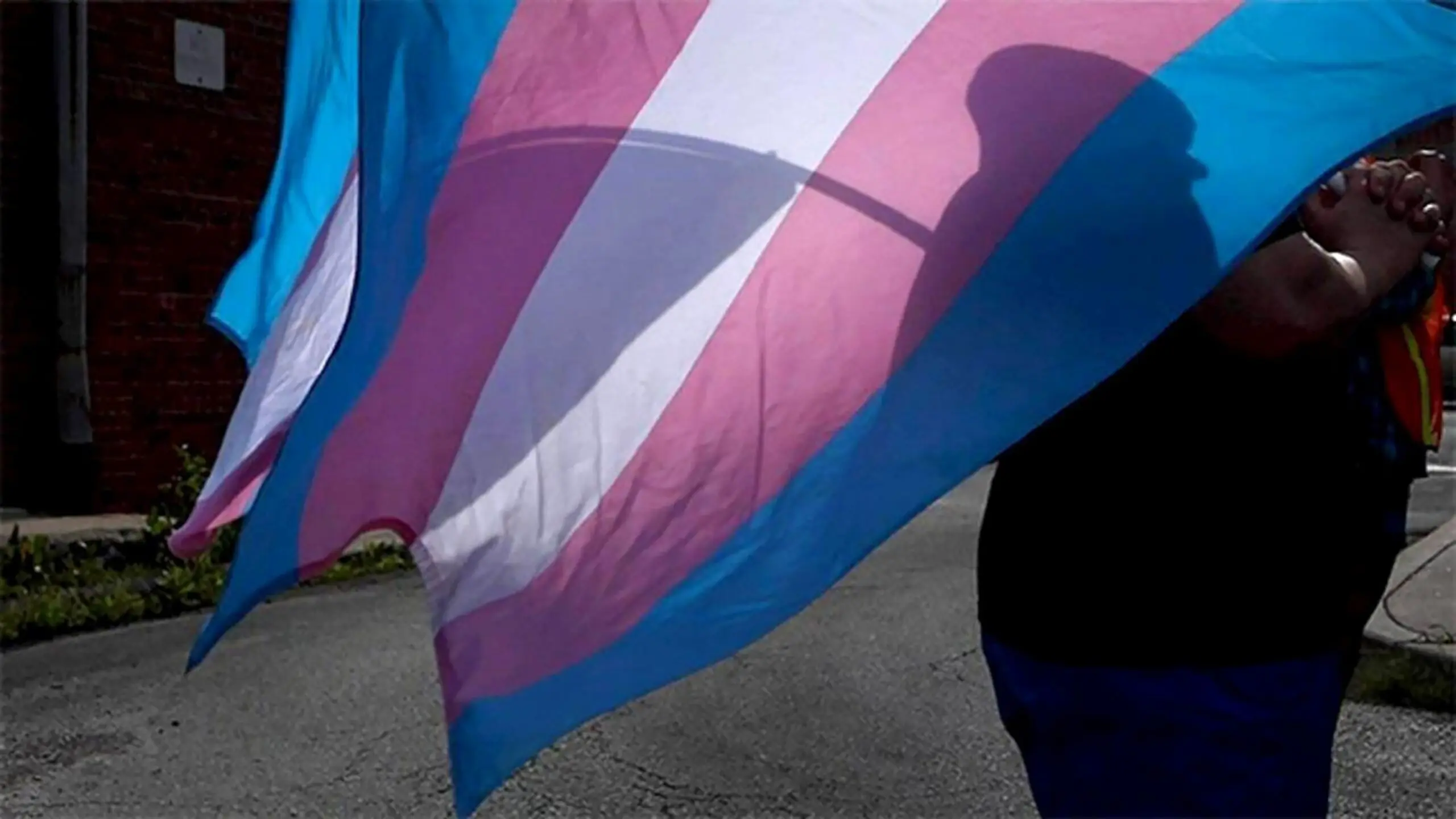 PHOTO: During a protest in Kansas City, a activist carries a Transgender Pride symbol.