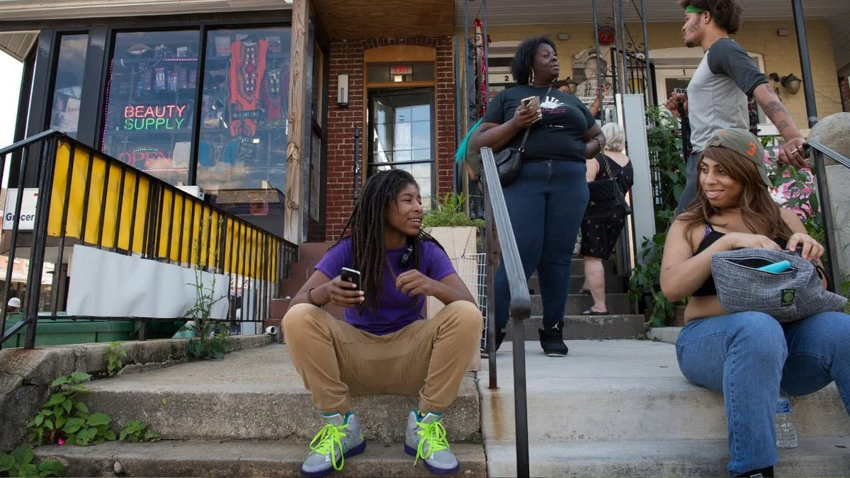 People sittign and talking outside an LGBT non-profit