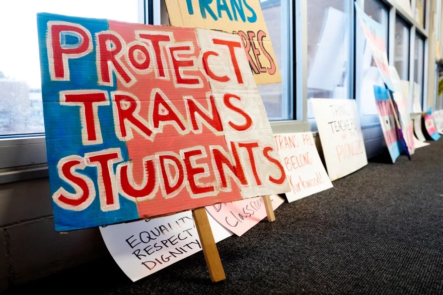 Signs brought in by supporters of queer and diverse teachers are propped up after being confiscated by school security on Monday, April 17, 2023, before a school board meeting at North Kirkwood Middle School in Kirkwood.