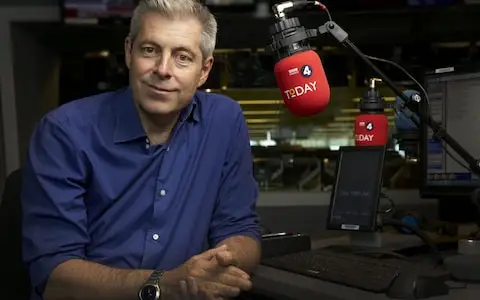 Justin Webb sits in a radio studio with a Today Programme-branded microphone