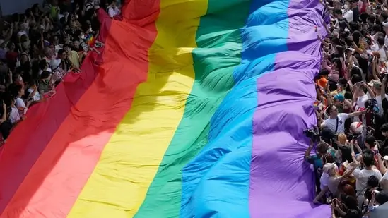 A kaleidoscope flag is raised by individuals in Bangkok's Pride Parade. ( AP )