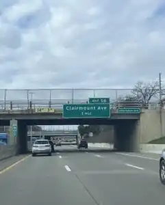 A sign for Clairmount Ave where the LGBTQ Ruth ellis Center is. The sign is green reading 