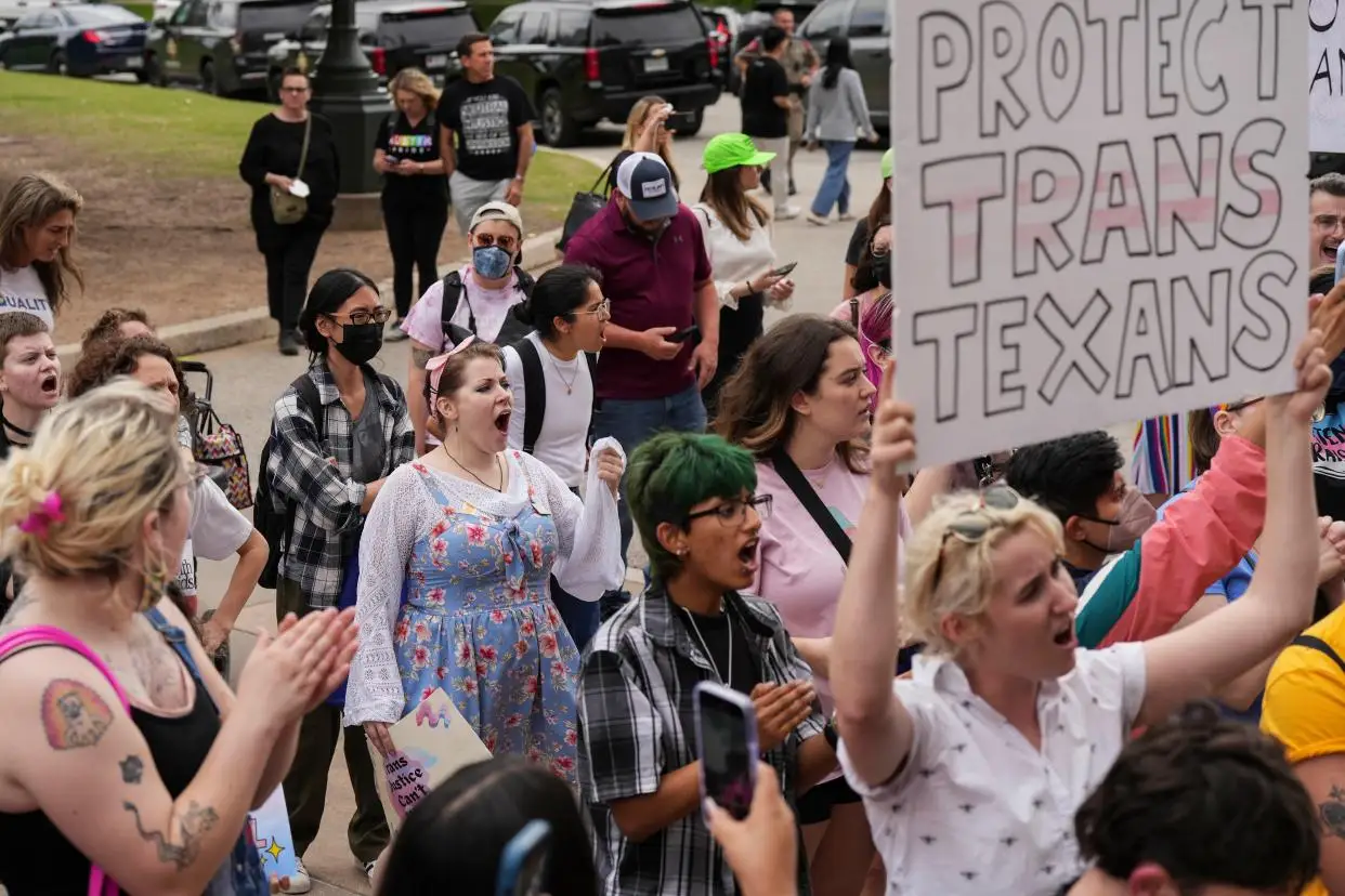 LGBTQ+ rights activists protest Senate Bill 14 past May. In Texas, SB 14 forbids gender-affirming health treatment for transgender children.