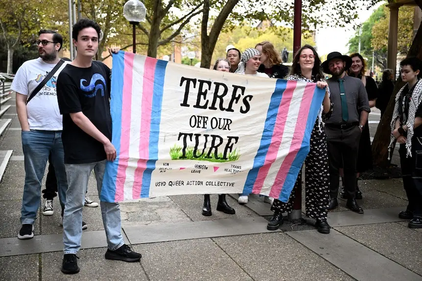 A group of protesters holding a banner.