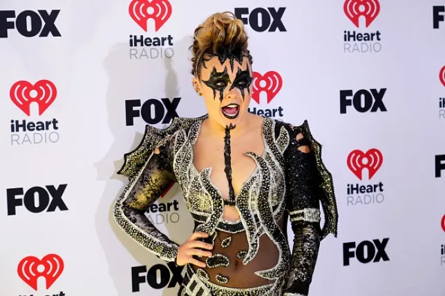 Jojo Siwa wearing black makeup and a black and white rhinestone outfit.