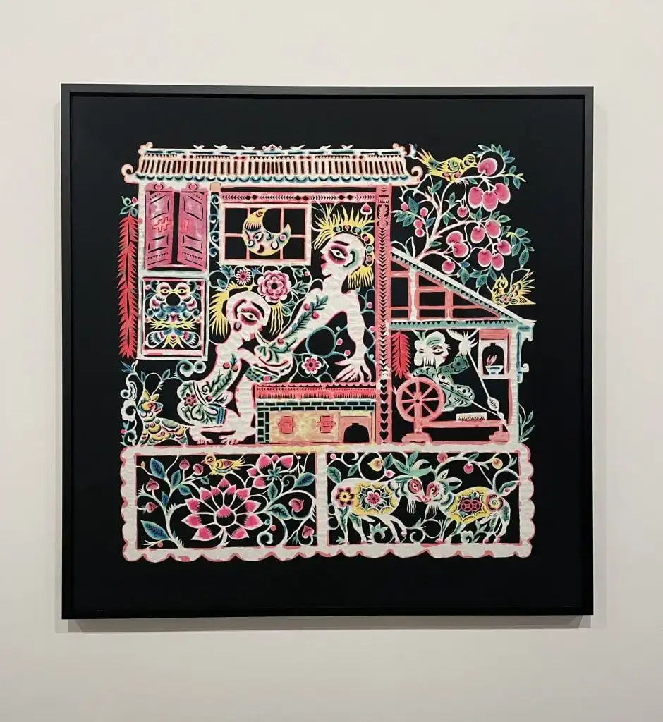 A colourful papercut artwork depicting a graphic homosexual scene