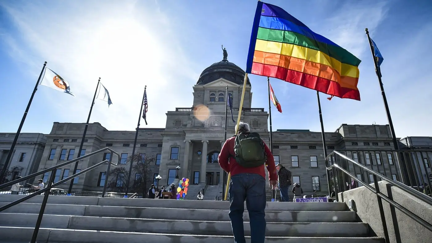 FILE - Demonstrators gather on the steps of the Montana state Capitol protesting anti-LGBTQ+ legislation in Helena, Mont., March 15, 2021. A Montana state judge Wednesday, Sept. 27, 2023, has blocked enforcement of a law to ban gender-affirming medical care for minors. (Thom Bridge/Independent Record via AP, File)