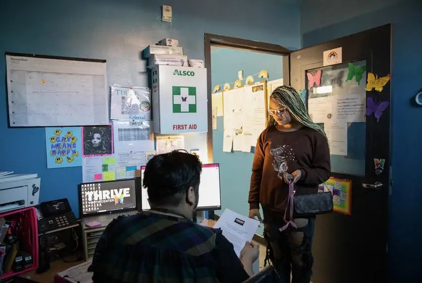 On the morning of Nov. 21, 2023, Jai Gonzalez Quintero, a case manager at Thrive Youth Center, hands Isabella Morningstar a letter stating that she is homeless so she can apply for financial aid at Palo Alto College, where she has recently started a cosmetology program.