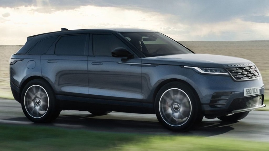 Gray Land Rover Range Rover Velar driving near water.