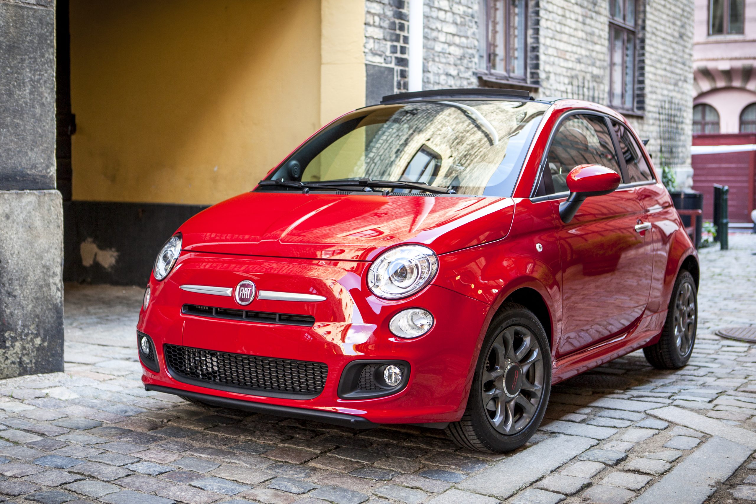 A brand new Fiat 500 sits parked in a street in Malmoe