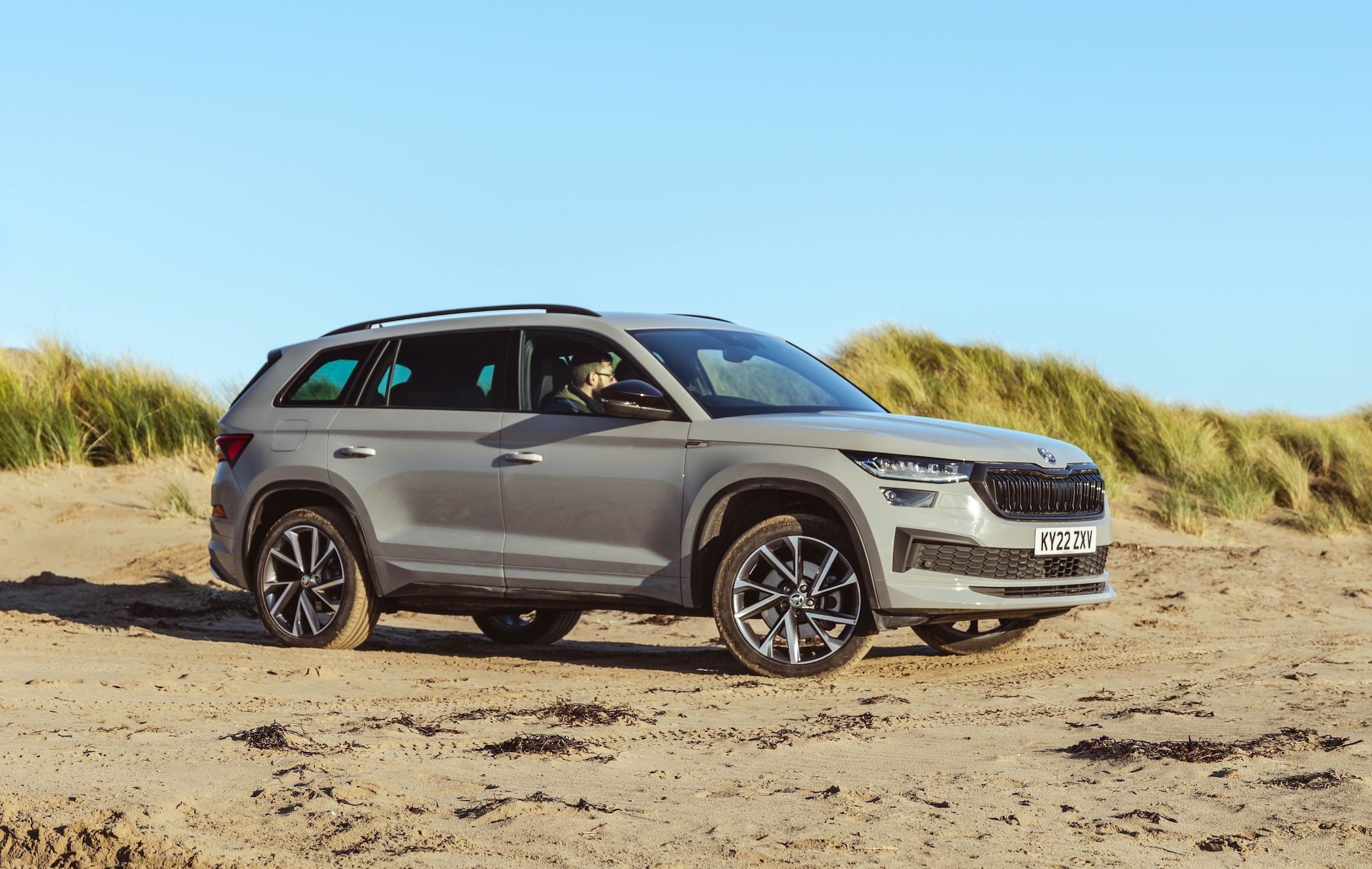 Grey Skoda Kodiaq parked on sand