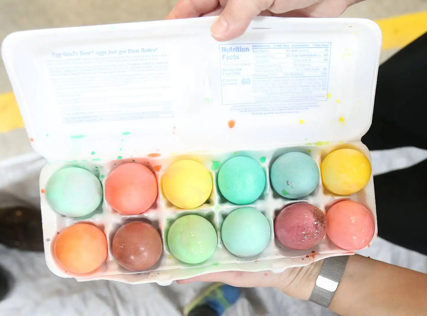 Colorful Easter eggs are put into a container as Utica volunteers and personnel help dye them for the departments annual Easter Egg Hunt on Friday, April 7, 2023 at the Utica Fire Station. The hunt takes place Saturday morning at 11a.m. in Carey Memorial Park in Utica. The Utica Fire Department has hard boiling the eggs for their hunts since the 1970’s.