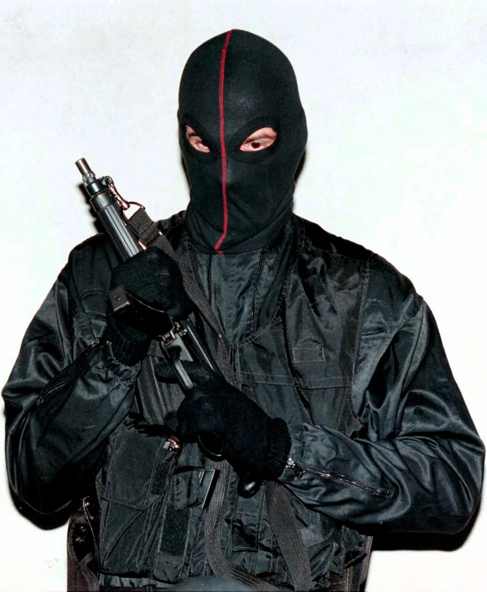 A gun-wielding Corsican gangster poses