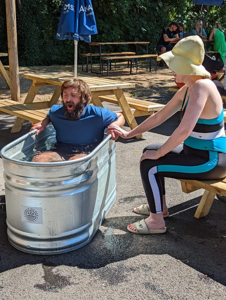 Joe in Ice bath & Katherine sitting, post yoga paddle boarding The Red Lion Pub, Bishopgate Norwich Pictured: Joe Wilkinson & Katherine Ryan Joe & Katherine's Bargain Holidays S1 Ep1 Norfolk TV still Channel 4