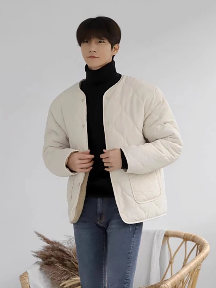 Korean Men's fashion: Minimalist Cream Quilted Jacket Layered + Sleek Black Turtleneck + Slim-Fit Blue Jeans