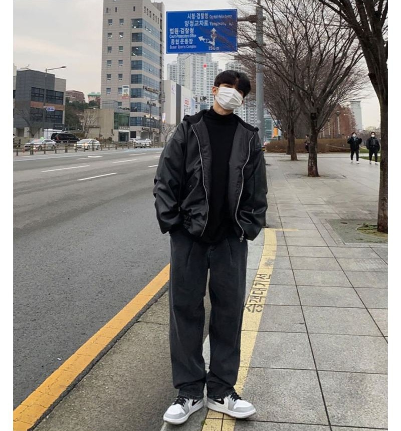 Korean Men's fashion: Oversized Black Leather Jacket Layered Over A Classic Black Turtleneck + Loose-Fitting Charcoal Gray Trousers