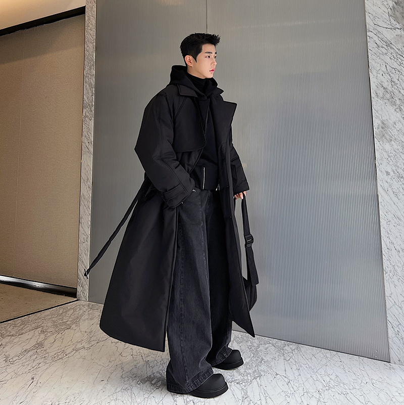 Korean Men's fashion: Long Black Trench Coat Layered Over A Sleek Black Hoodie + Wide-Leg Black Jeans + Chunky Black Boots