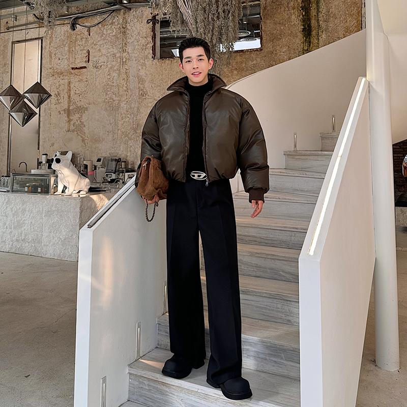 Korean Men's fashion: Cropped, Oversized Brown Puffer Jacket with A High Collar, Layered Over A Sleek Black Turtleneck + Wide-Leg Black Trousers + Chunky Platform Boots