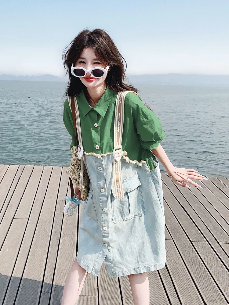 Oversized White Sunglasses + Kelly-Green Shirt Dress Overlay + Light-Wash Denim Apron Dress + Canvas Webbing Straps + Mini Raffia Pouch + White Low-Top Sneakers