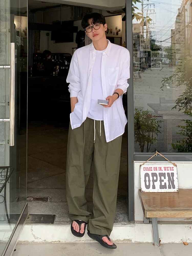 White Overshirt + Olive Drawstring Wide-Leg Pants + Black Thong Sandals