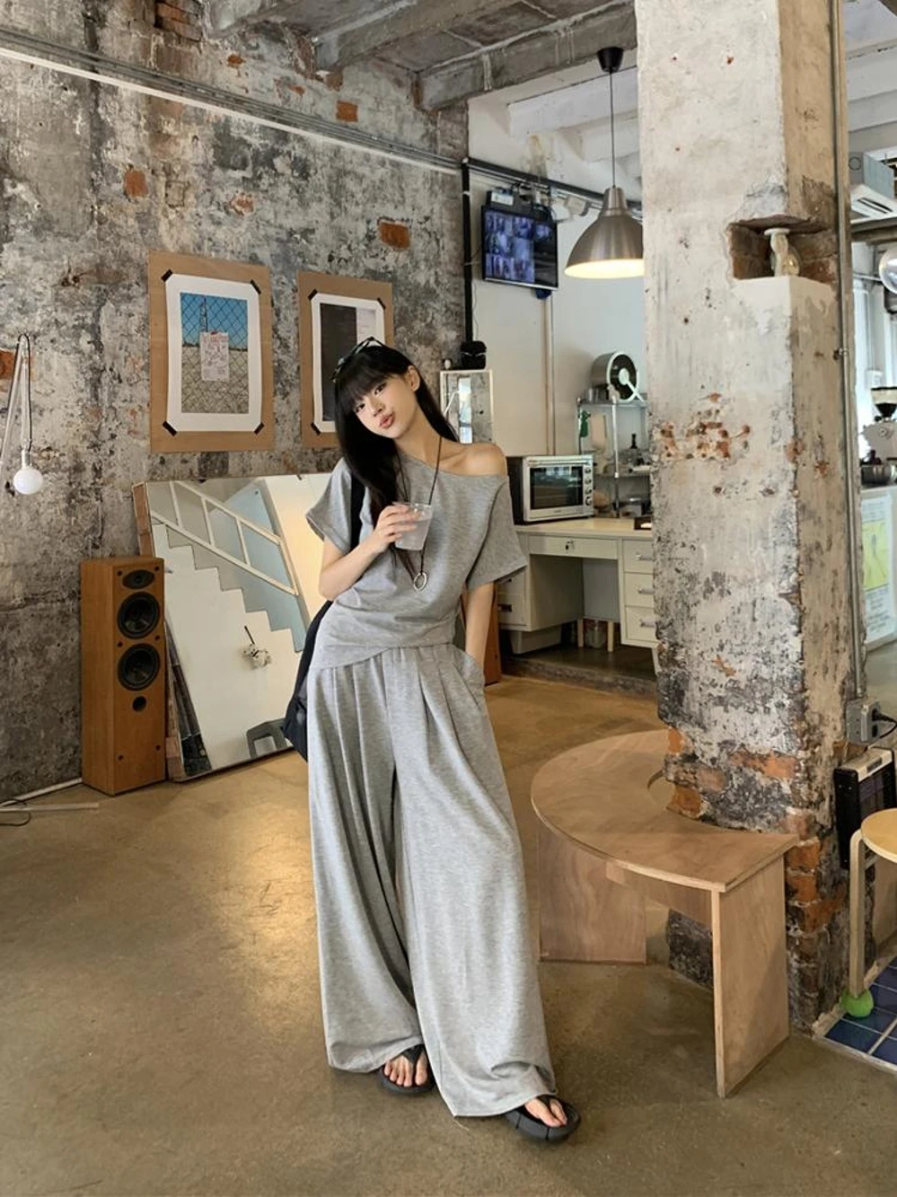 Asymmetric Off-Shoulder Grey Tee + Draped Wide-Leg Jersey Pants + Black Flip-Flop Sandals