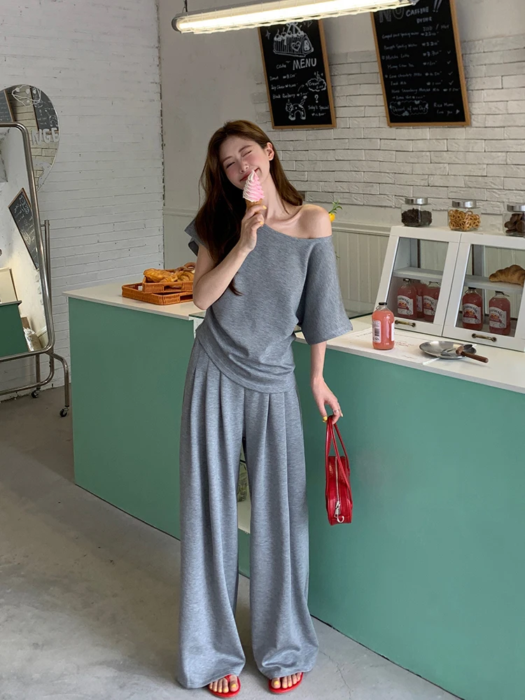 Asymmetric Off-Shoulder Grey Tee + Draped Wide-Leg Jersey Pants + Red Jelly Sandals