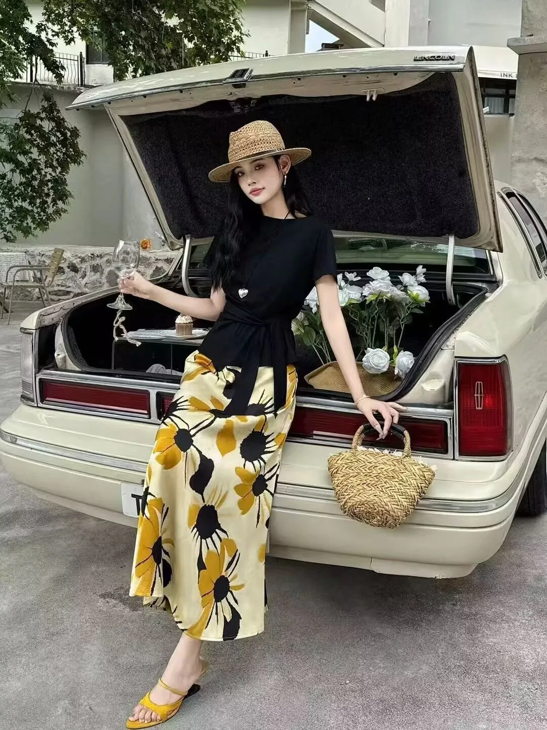 Straw boater hat + black belted tee + sunflower satin midi skirt + yellow sandals
