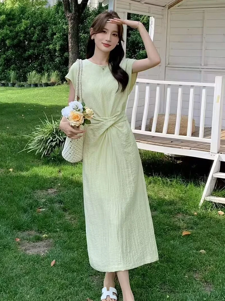 Half-up pony + mint knot-front midi dress + white slide sandals + crochet shoulder bag