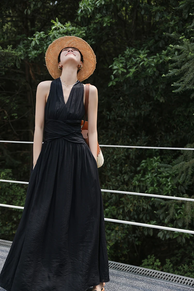 Straw sun hat + deep-V black maxi dress