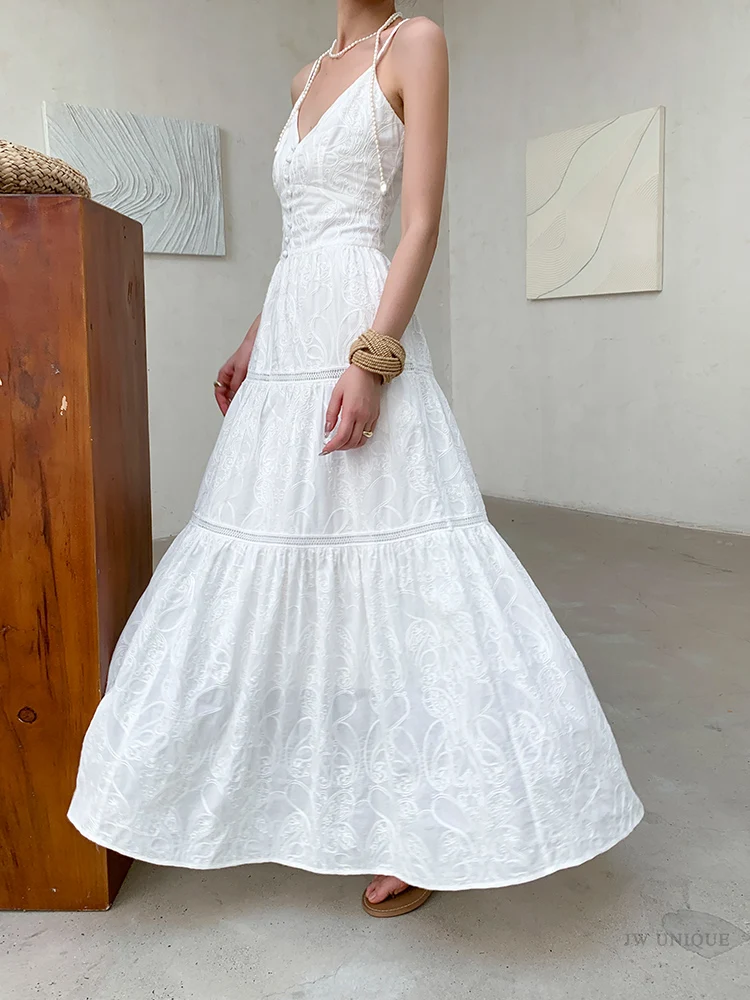 Pearl-loop halter strap + white embroidered tiered sundress + rope-coil cuff
