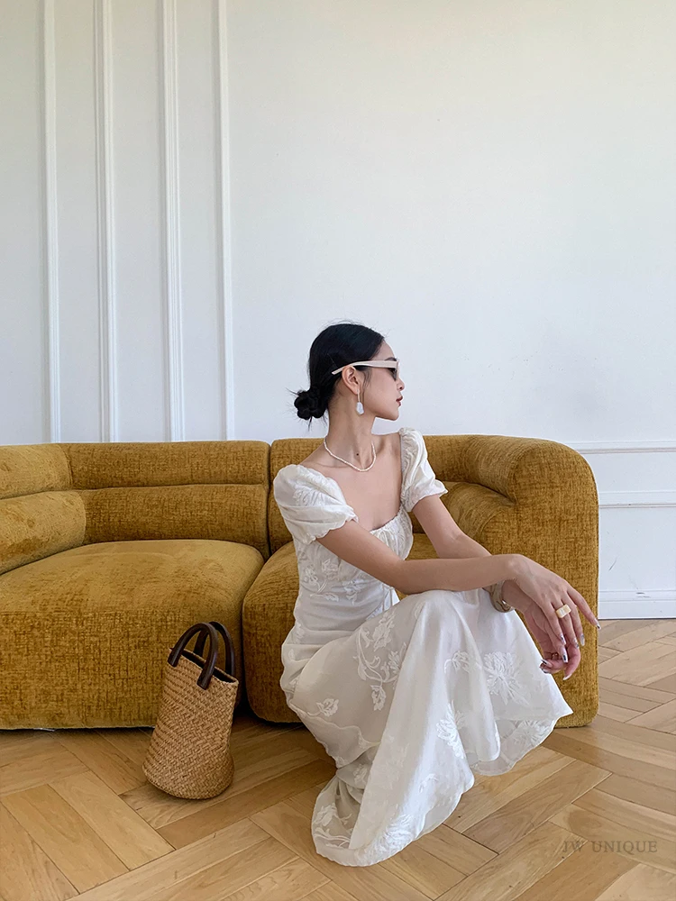 Minimal visor bun + ivory puff-sleeve sweetheart dress + oval sunglasses