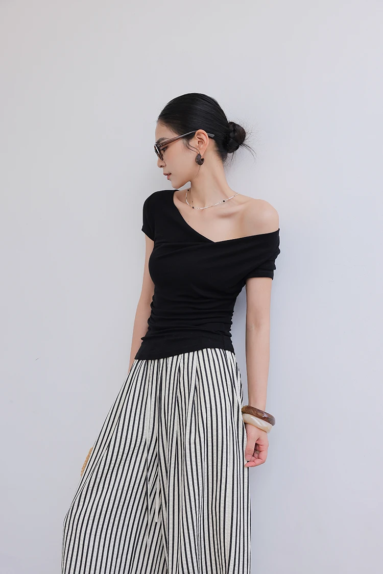 Wispy bun + toile-print tiered sundress + leather slides