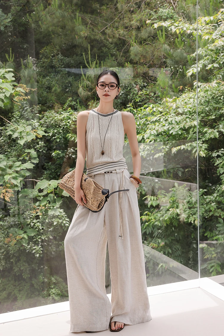 Square glasses + cable-knit tank + sand linen palazzos