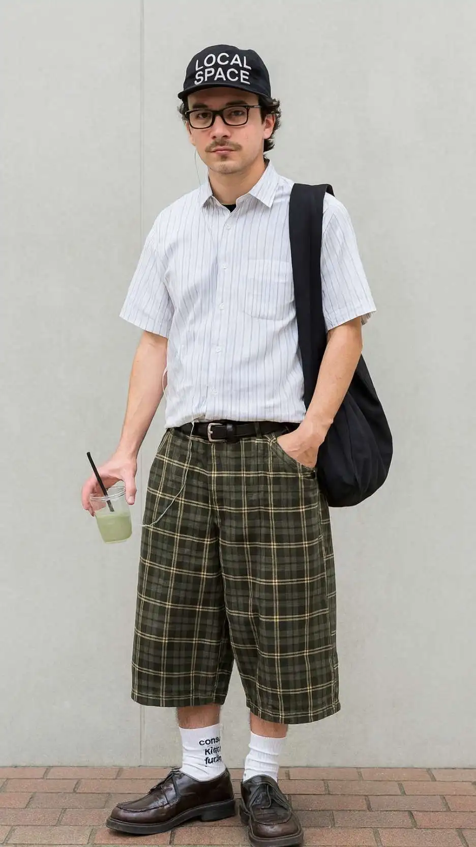 Black “Local Space” Cap + Striped Short-Sleeve Shirt + Olive Plaid Culotte Shorts + White Long Socks + Brown Leather Loafers