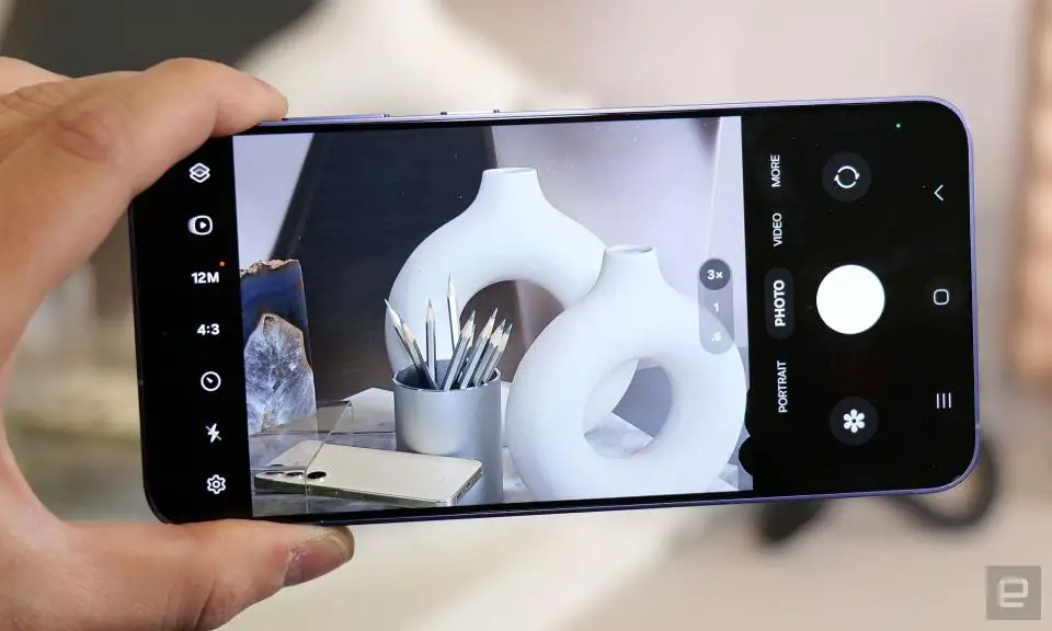 The Galaxy S24 held in mid-air, with the viewfinder of its camera app showing on the screen.