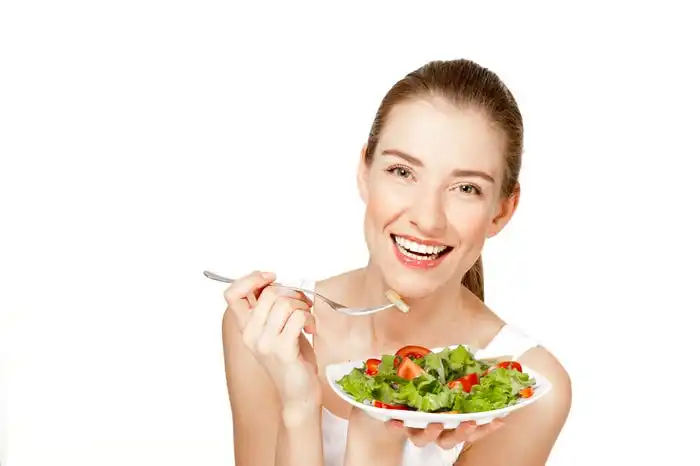woman laughing with salad