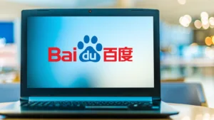 An image of a laptop on a table with the screen showing the red and blue logo for Chinese Internet company 