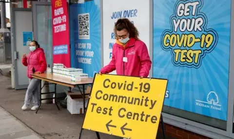 Getty Images Officials outside of a Covid testing centre in London in December 2021