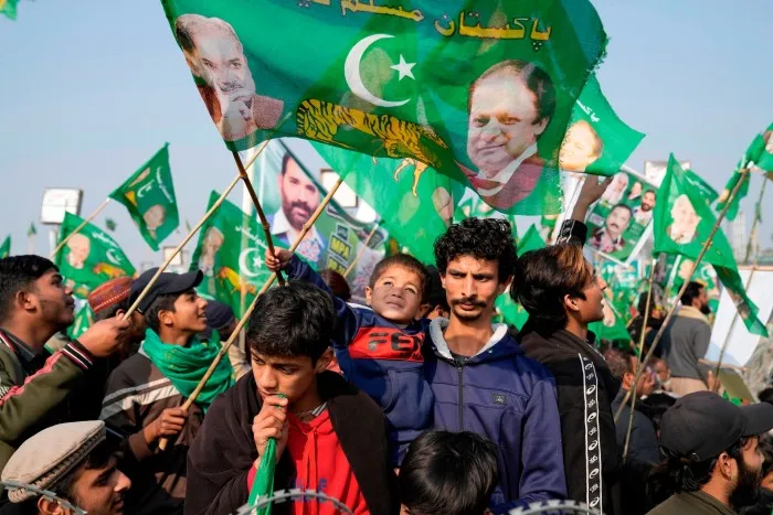 Supporters of Pakistan’s former Prime Minister Nawaz Sharif attend an election campaign rally in Hafizabad