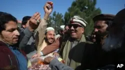 Independent candidate Malik Tariq Awan, centre right, joins supporters in celebrating his success in the parliamentary elections in Peshawar, Pakistan, on February 9, 2024.