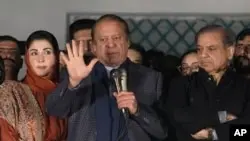 Pakistan’s Former Prime Minister Nawaz Sharif, center, addresses supporters following initial results of the country’s parliamentary election, in Lahore, Pakistan, Feb. 9, 2024. Sharif said Friday he will seek to form a coalition government.