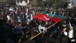 Supporters of imprisoned Pakistan’s Former Prime Minister Imran Khan’s party block a road as protest against the delaying result of parliamentary election by Pakistan Election Commission, in Peshawar, Pakistan, Feb. 9, 20204.