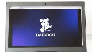 The Datadog ( DDOG ) logo displayed on a laptop screen.