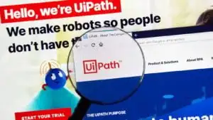 A magnifying glass zooms in on the website homepage of UiPath ( PATH).