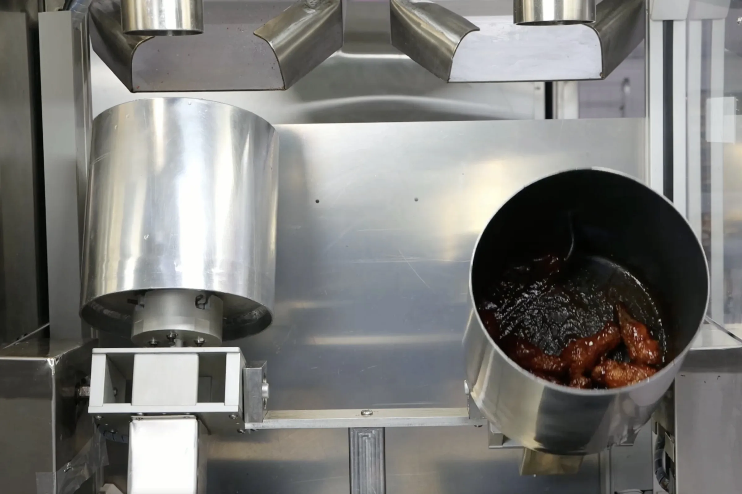 A picture of stainless steel buckets used by Nala Robotics’ robotic fry station.